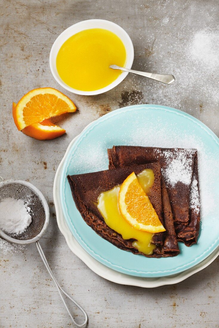 Chocolate pancakes with orange sauce