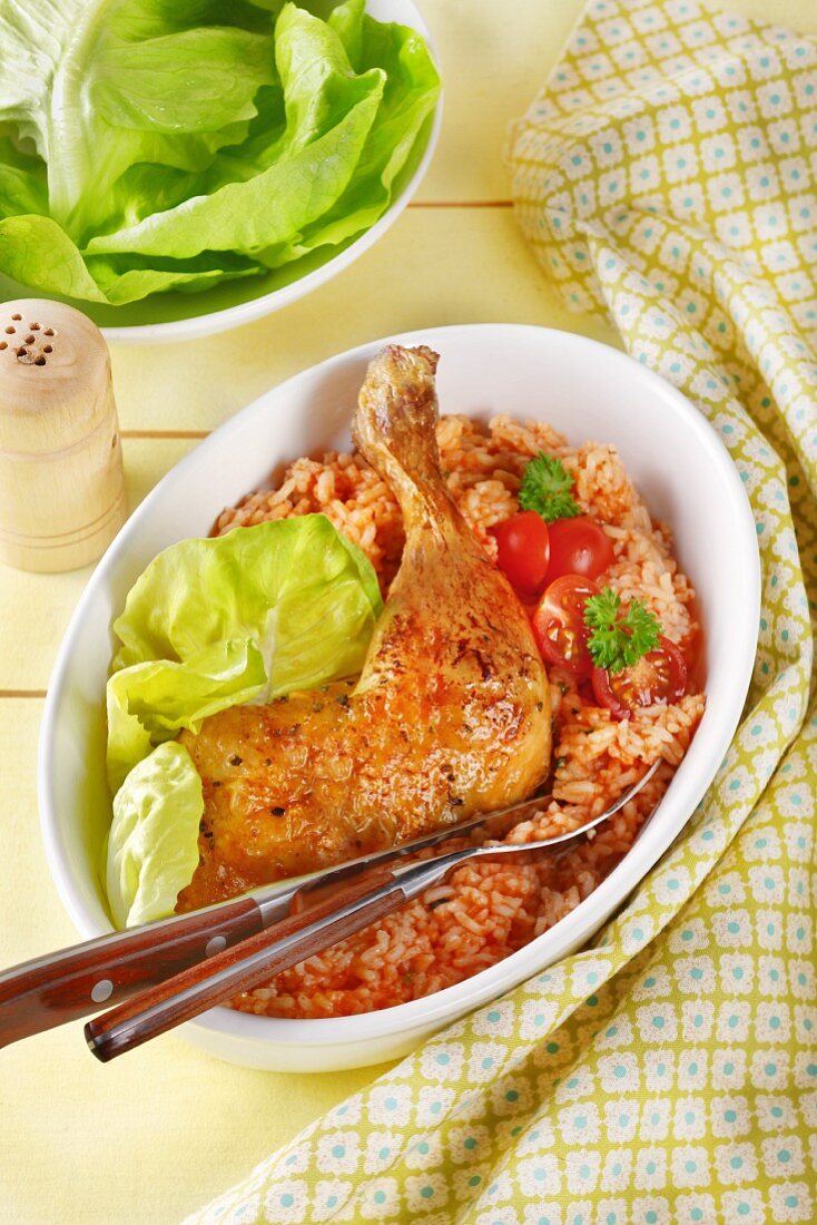 Roasted chicken leg on a bed of tomato rice