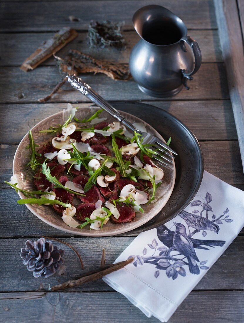 Venison carpaccio with mushrooms, rocket and Parmesan