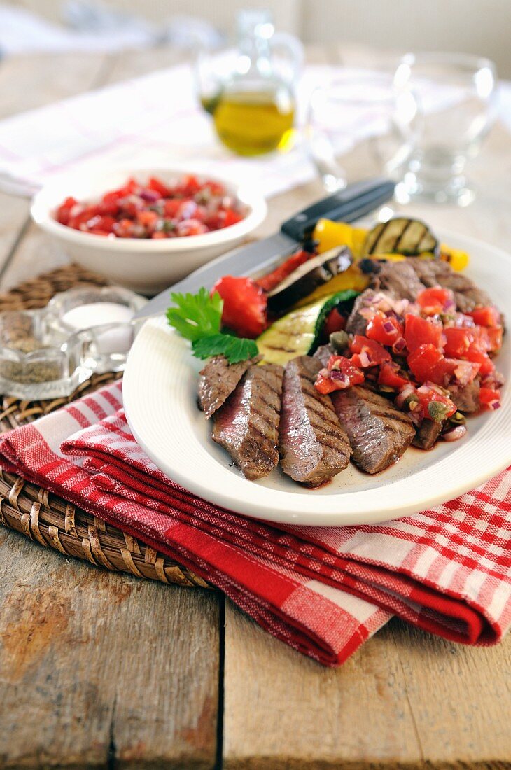Barbecued sirloin steak with grilled vegetables and tomato salsa