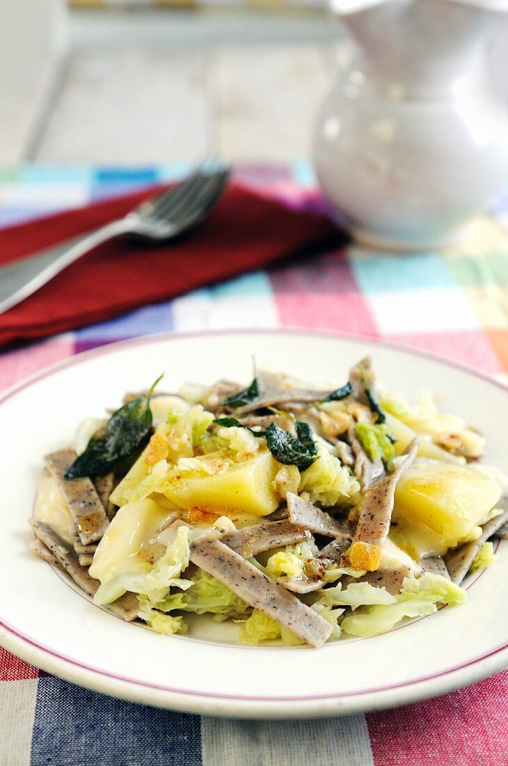 Pizzocheri della Valtellina (buckwheat pasta, Italy) with cheese, cabbage, potatoes and sage butter