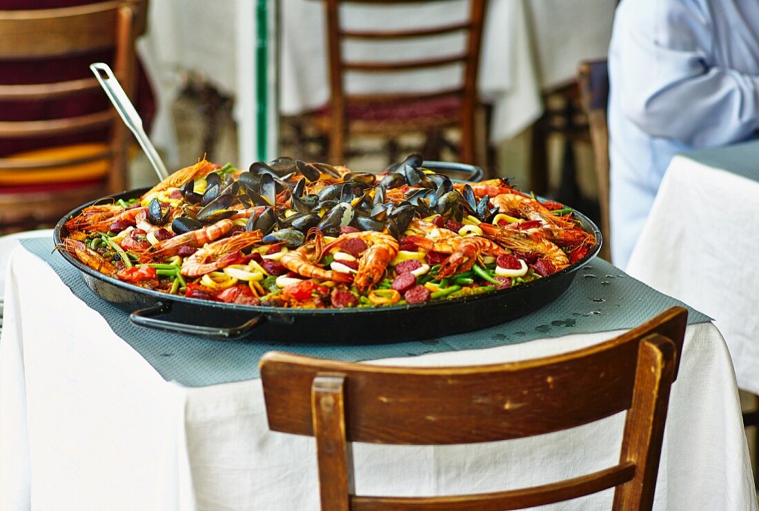 A pan of paella on a restaurant table