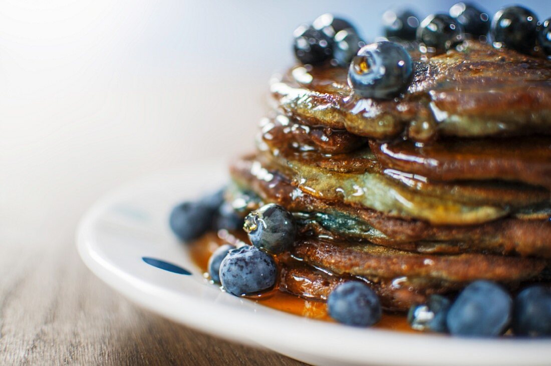 Blueberry Pancakes with Maple Syrup on a White Plate with a Spoon