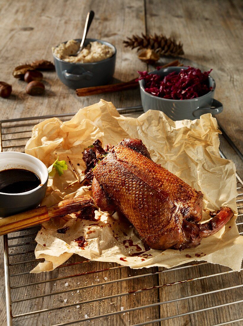 Cinnamon duck on a piece of baking paper with red cabbage and a soy sauce marinade