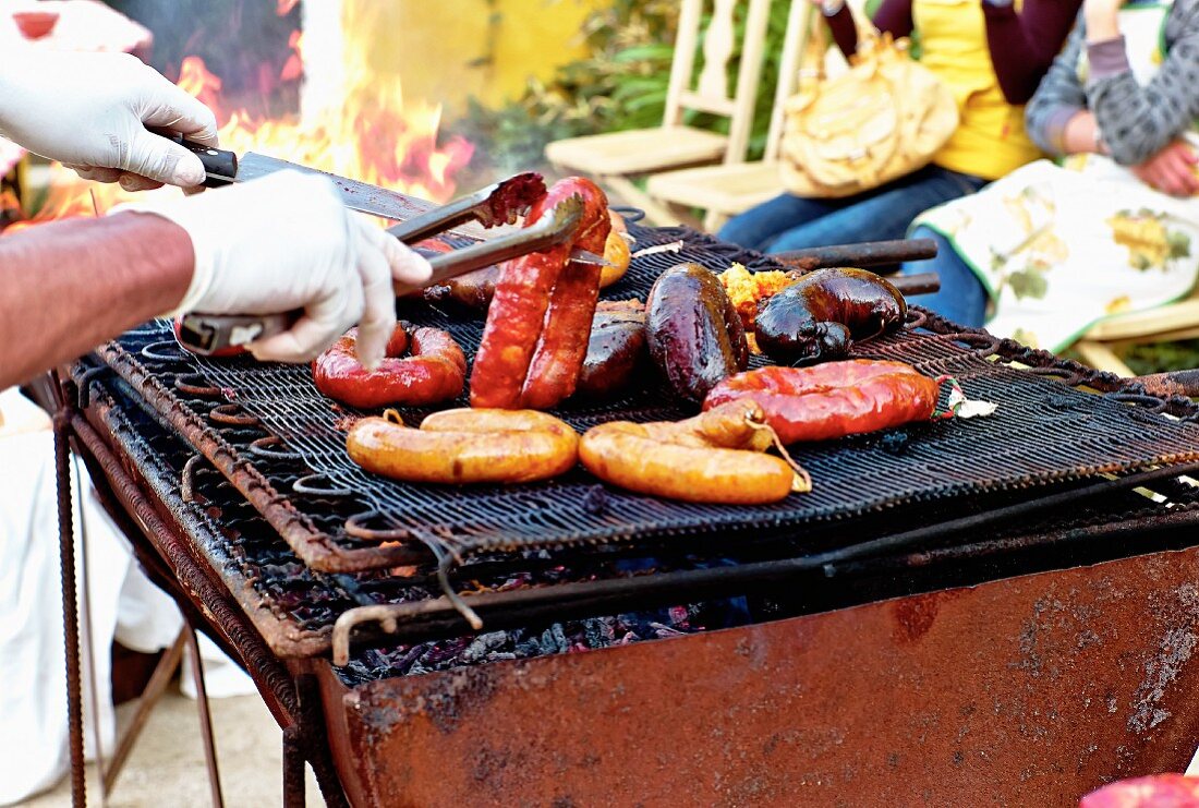 Various sausages on a rustic barbecue