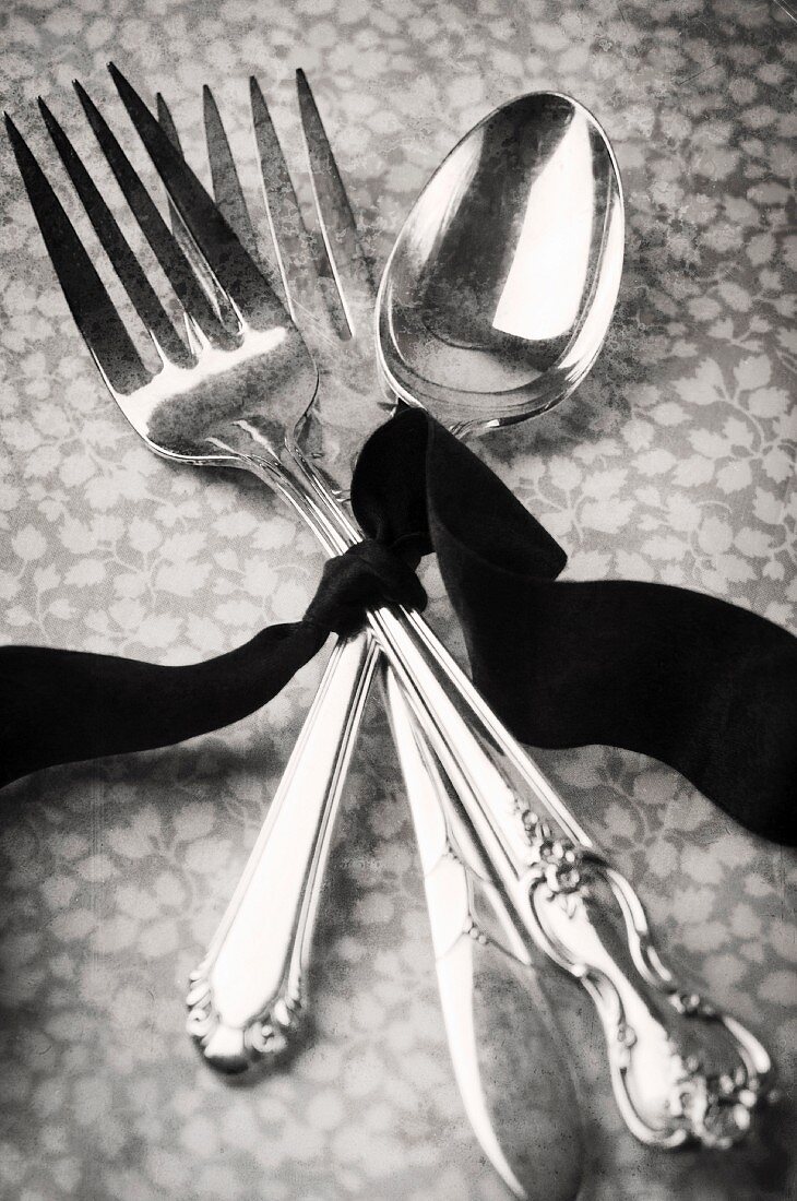 Silver forks and a spoons, tied with a ribbon