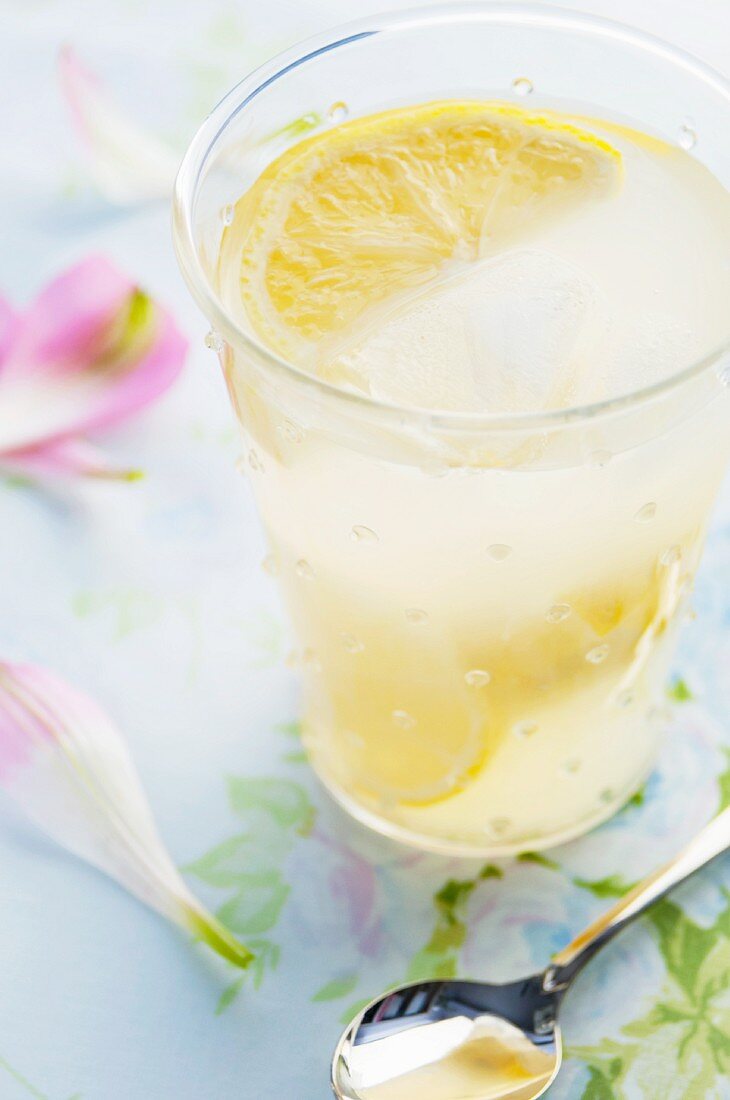 A glass of lemonade with a lemon wedge