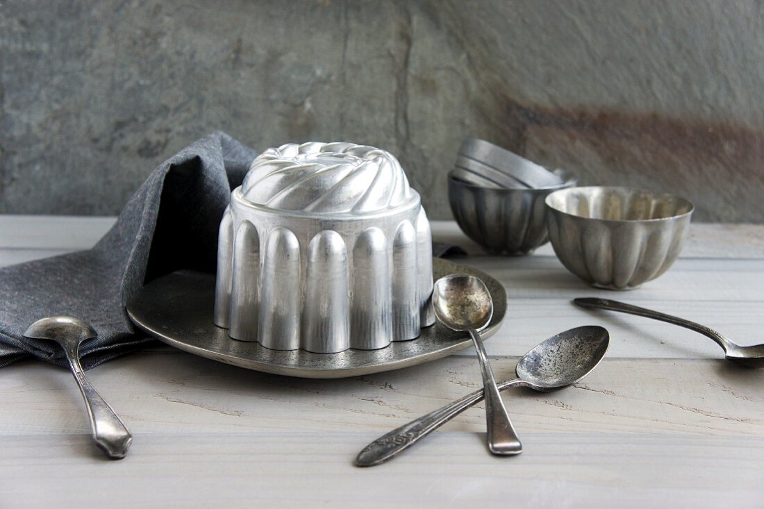 Various Bundt cake tins and spoons
