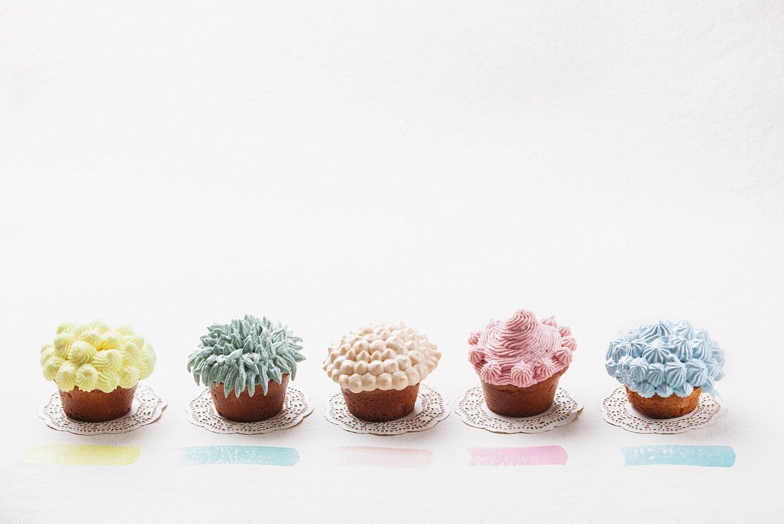 Cupcakes decorated with pastel-coloured cream