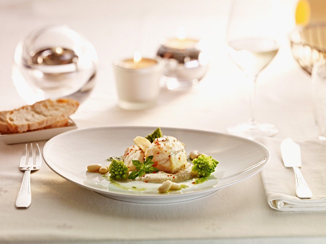 Monk fish medallions with pine nuts and romanesco cauliflower