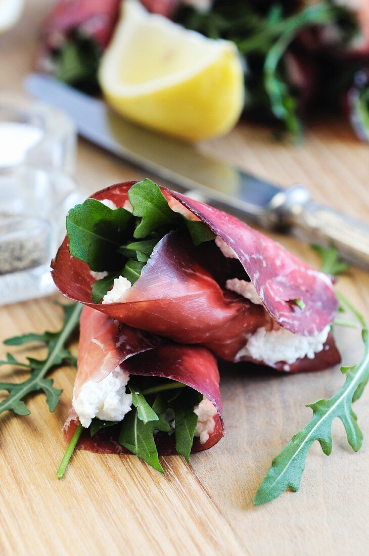 Bresaola (beef ham) rolls filled with ricotta and rocket