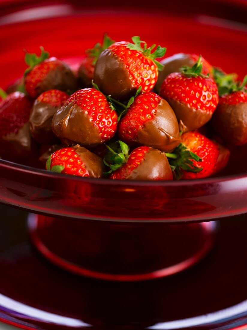 Chocolate strawberries in a red bowl