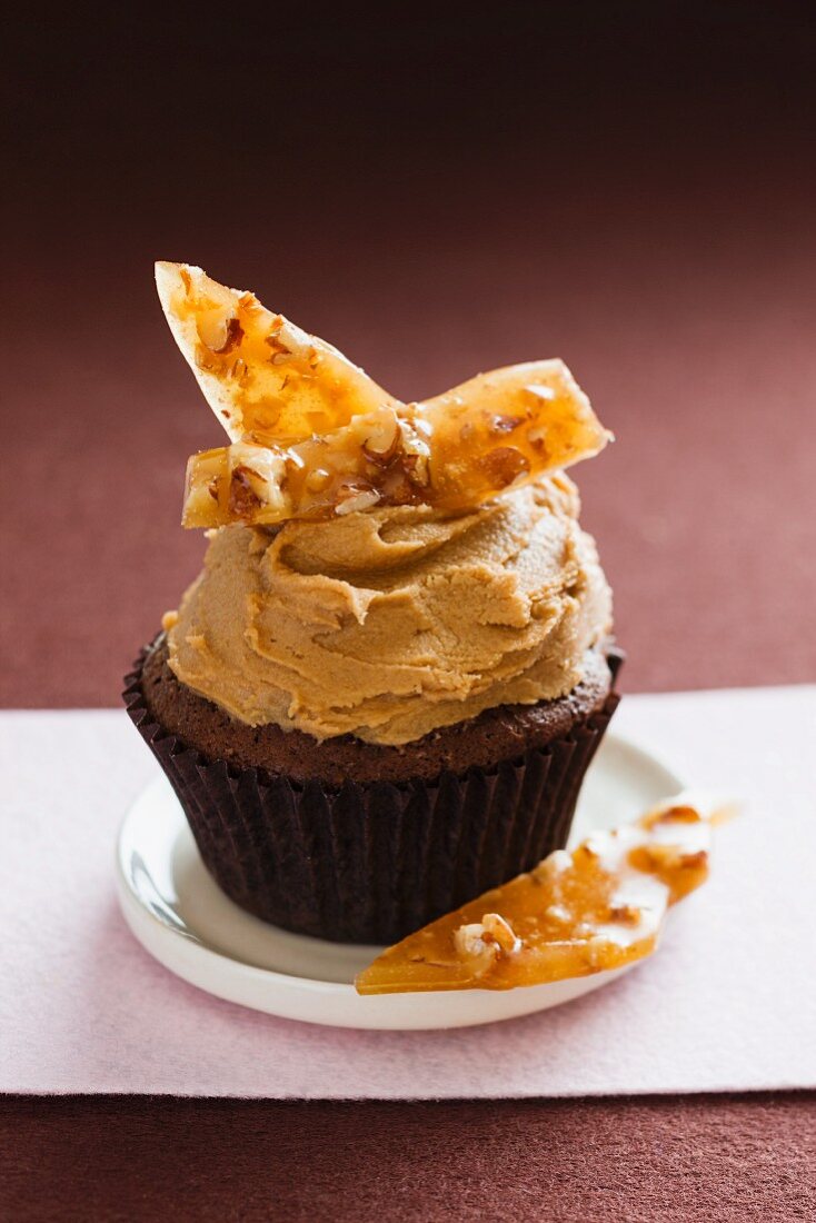 A chocolate cupcake topped with caramel