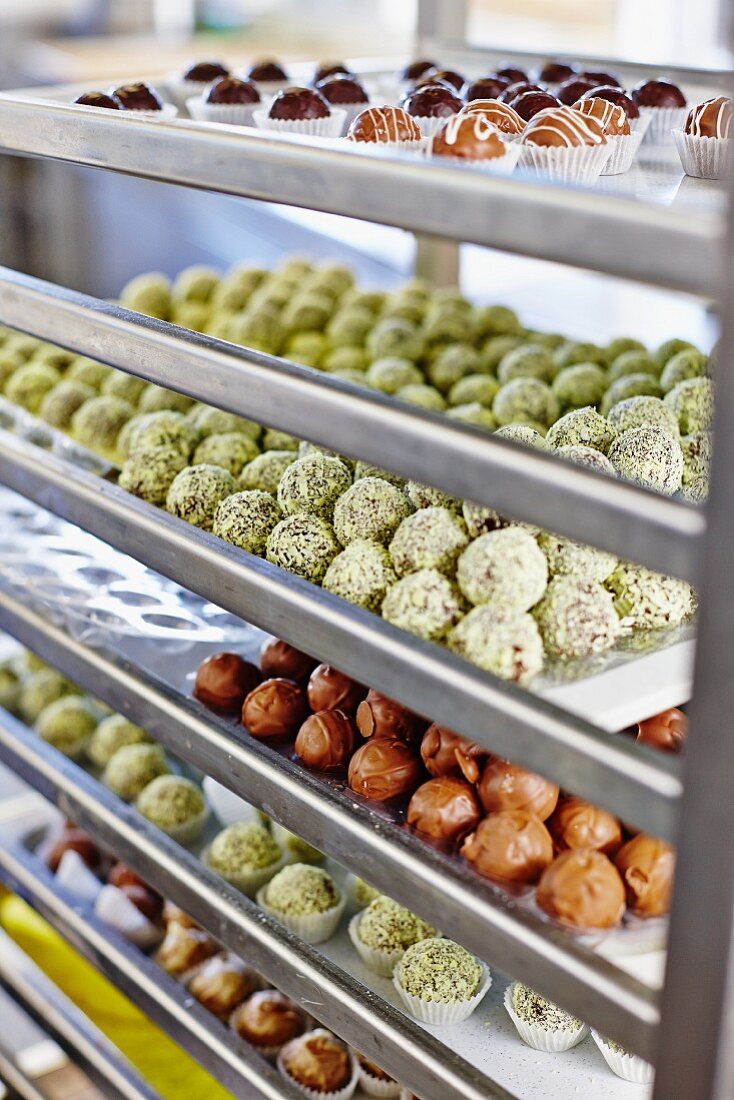 Various pralines on shelves in a confectioners