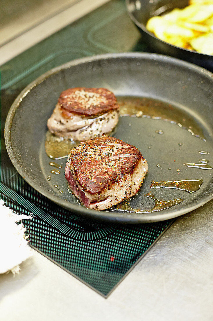 Beef fillet steaks in a pan