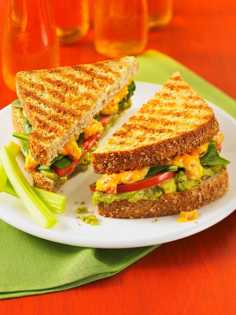 A toasted guacamento sandwich with avocado and Cheddar cheese