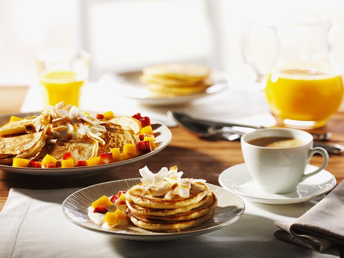 Breakfast with pancakes, fruit, coffee and orange juice