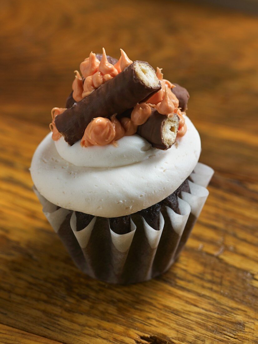 A chocolate cupcake decorated with a chocolate bar