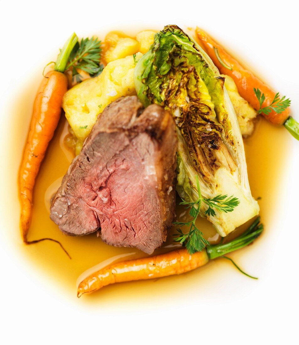 Lamb with roasted lettuce, carrots and mashed potatoes