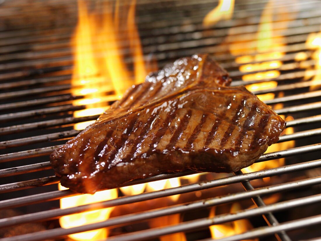 A T-bone steak on a barbecue