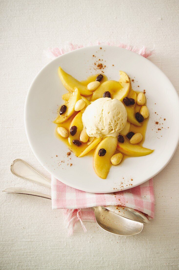 Roasted apple topped with vanilla ice cream, almonds and raisins