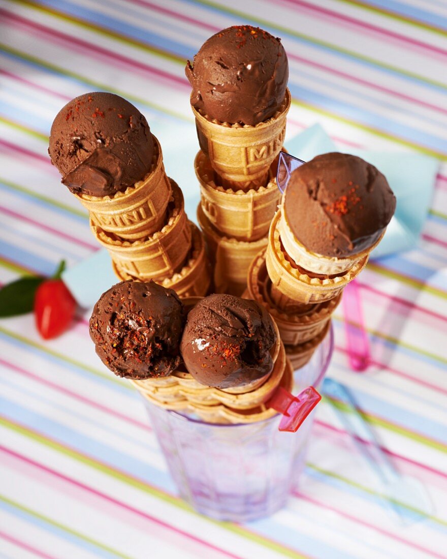 Chocolate ice cream in ice cream cones sprinkled with chilli powder