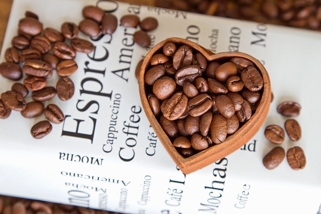 Coffe beans in a heart-shaped bowl