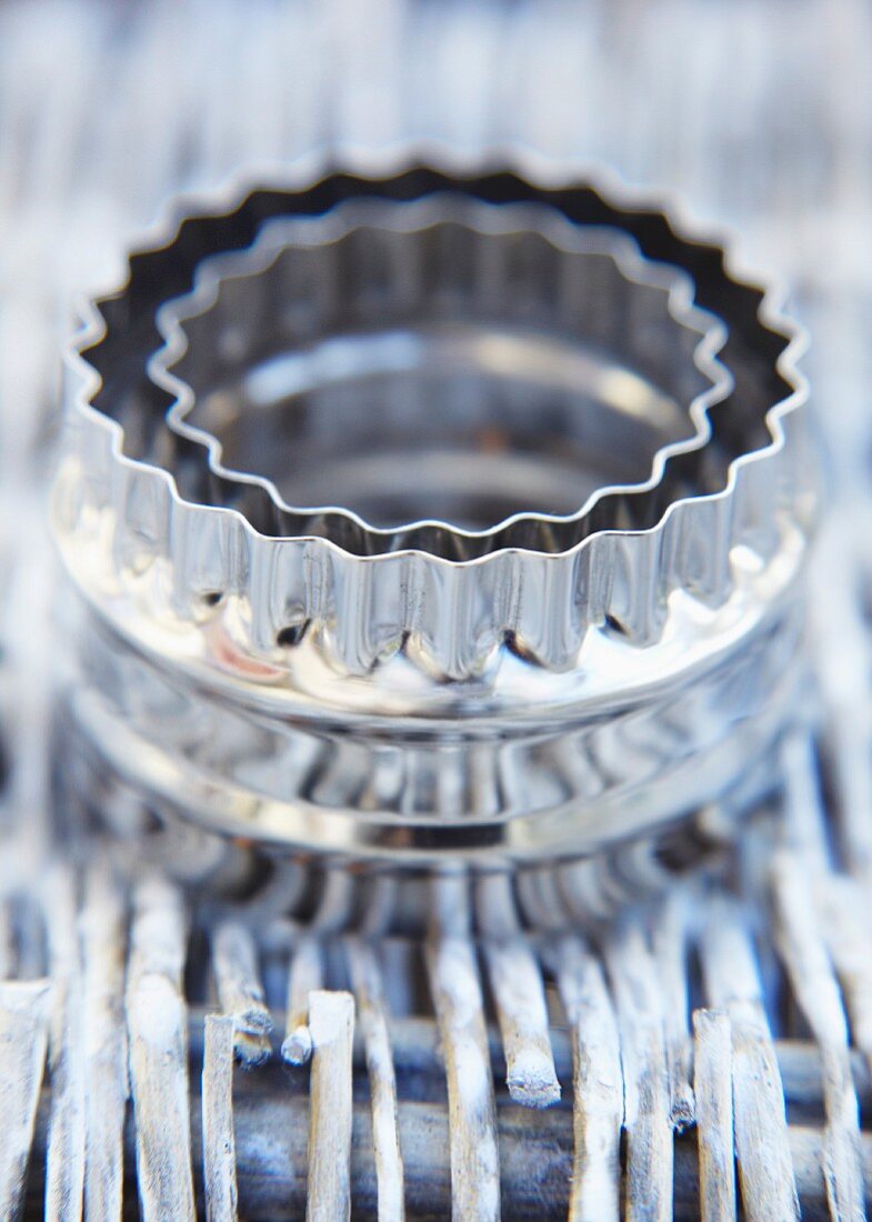 Cookie cutters on a woven mat