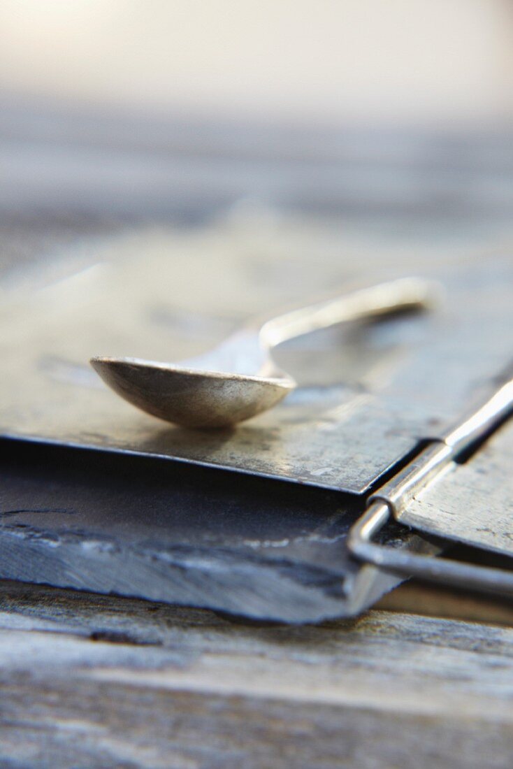 A metal spoon on a slate platter