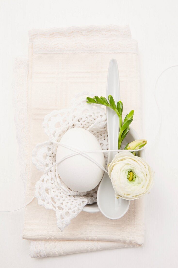 Egg decorated with flower and lace doily