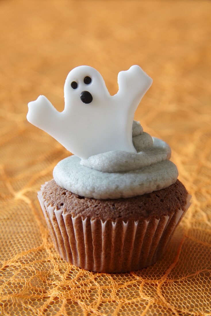A cupcake decorated with a ghost for Halloween