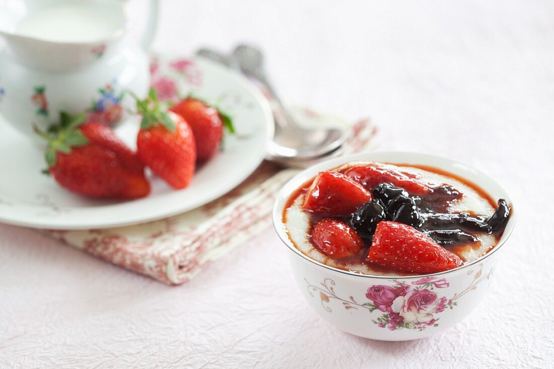 Porridge with berries in a floral coffee cup