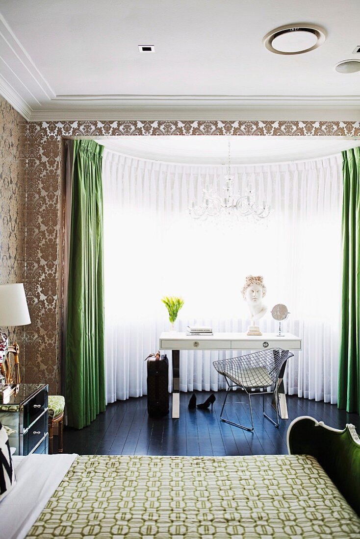 Bedroom with dressing table & Bauhaus chair in bay window, double bed & patterned wallpaper