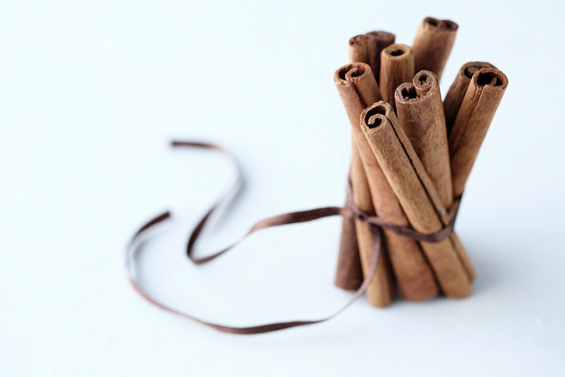 A bunch of cinnamon stick tied with a brown ribbon