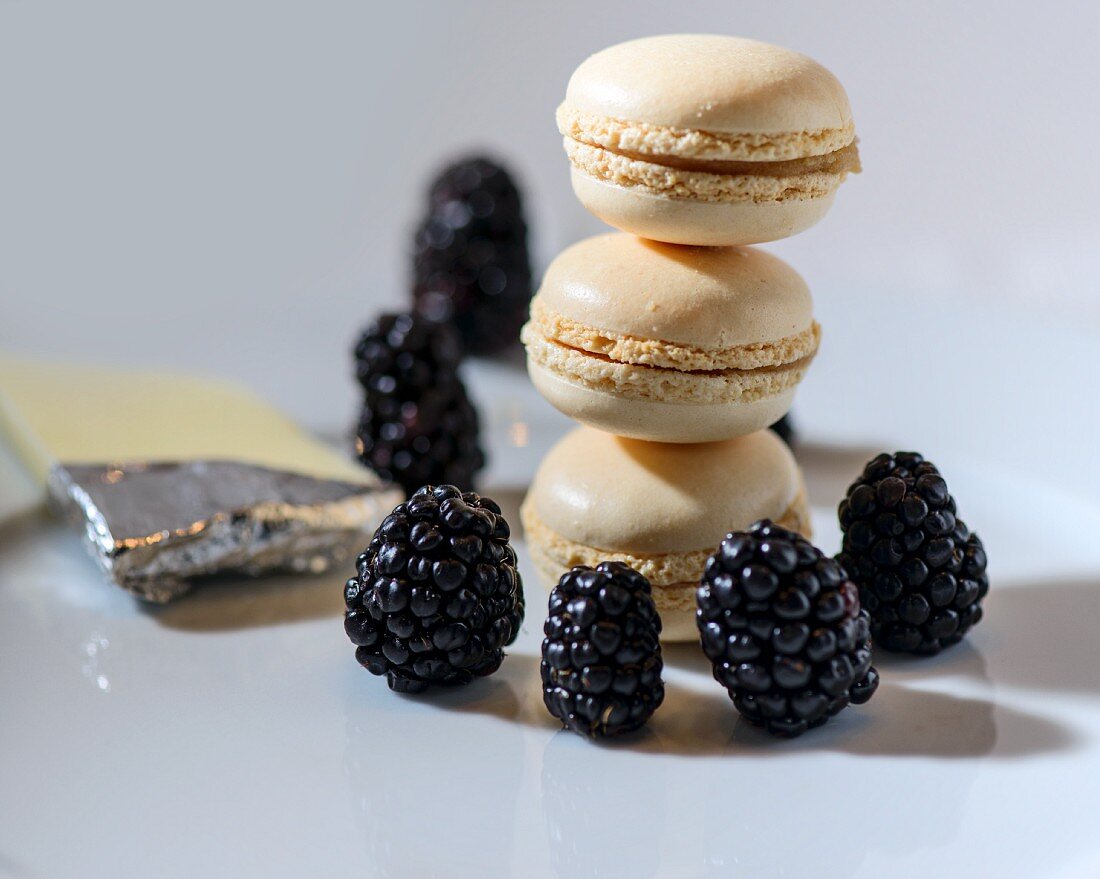 A stack of macaroons with blackberries and white chocolate