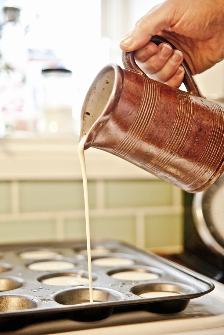 Yorkshire pudding batter being poured into a tin