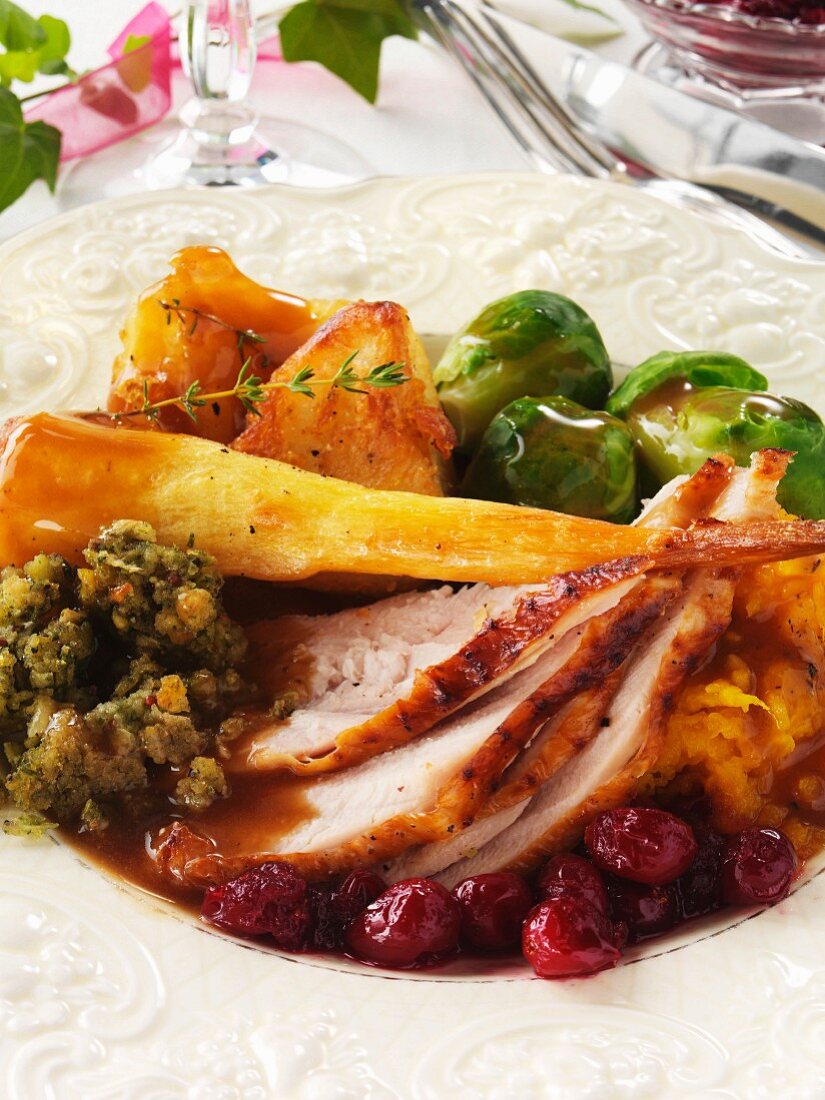 Roast turkey with Brussels sprouts, mashed sweet potatoes, cranberries and parsnips