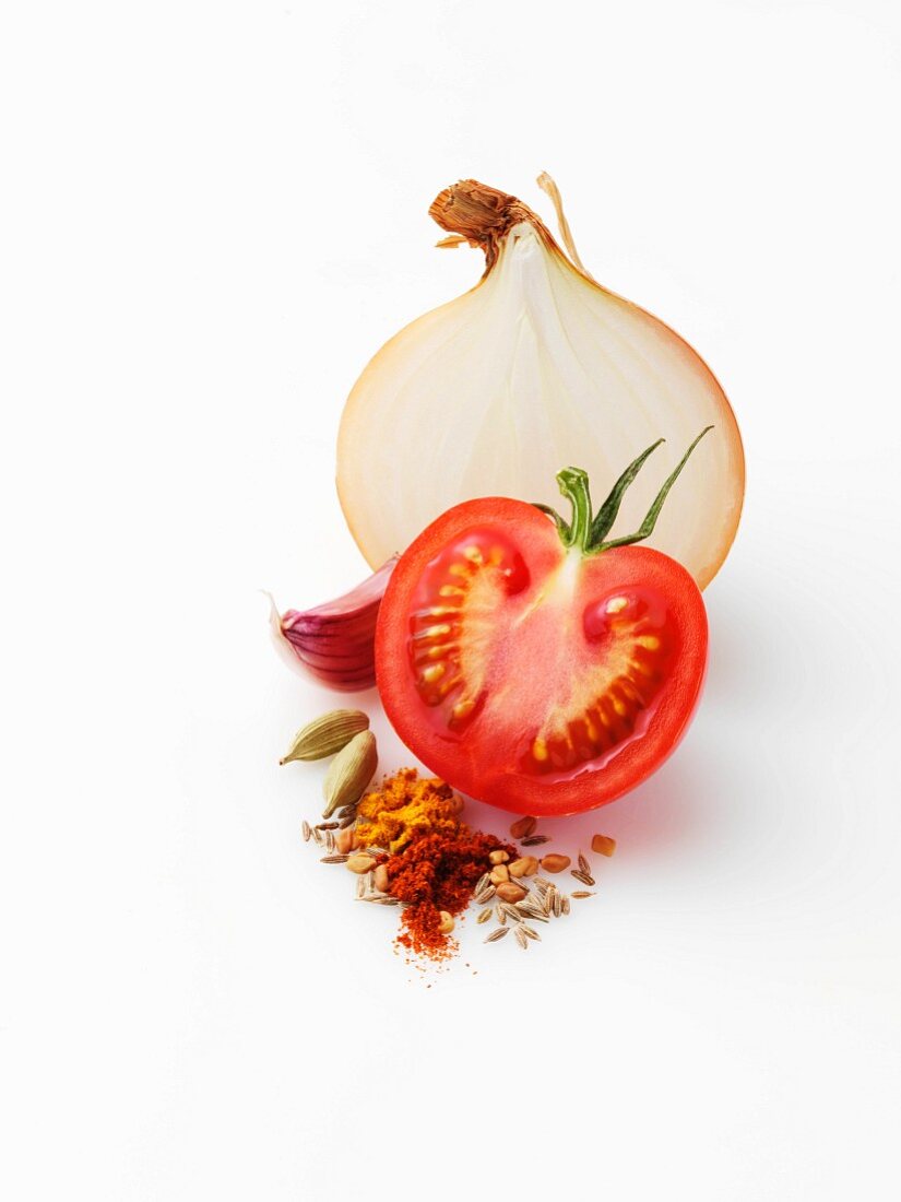 An arrangement featuring on onion, tomato and spices