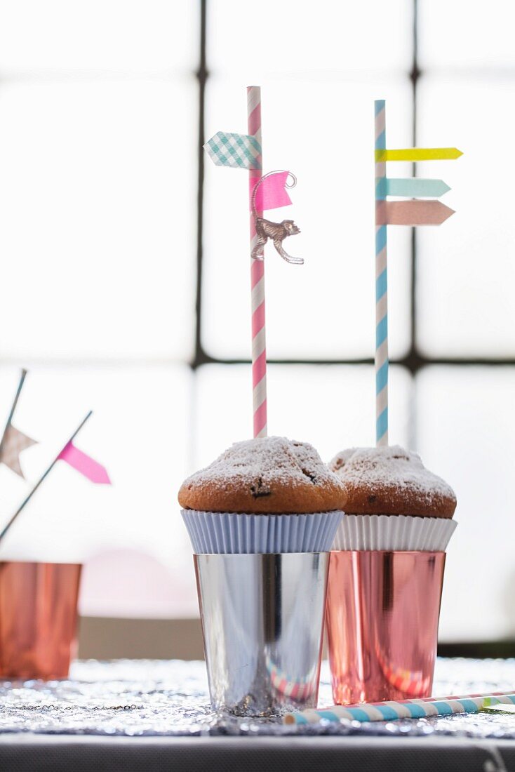 Drinking straws with washi tape flags stuck in muffins