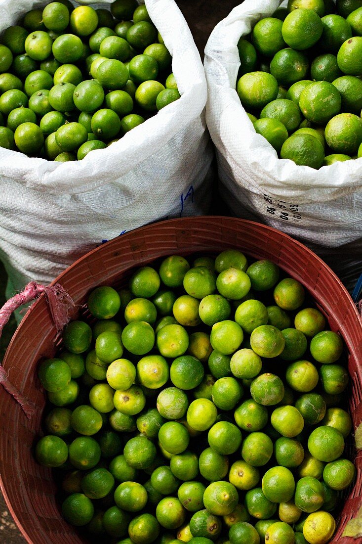 Limes in two sacks and a plastic container