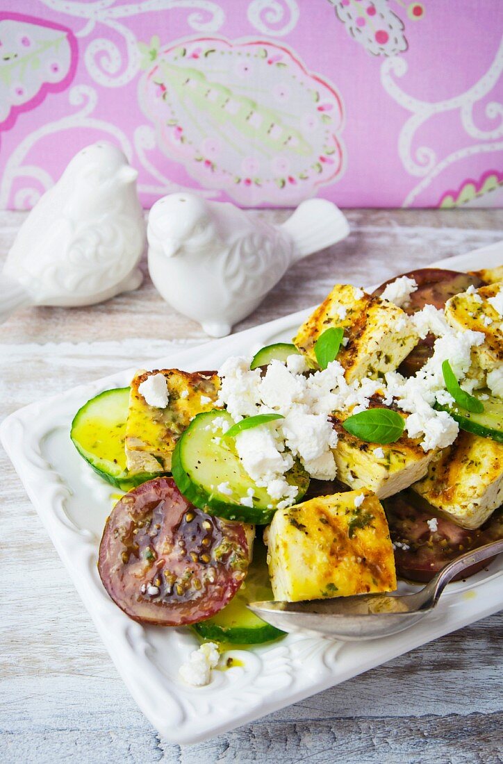 Tomato and cucumber salad with grilled tofu and feta cheese