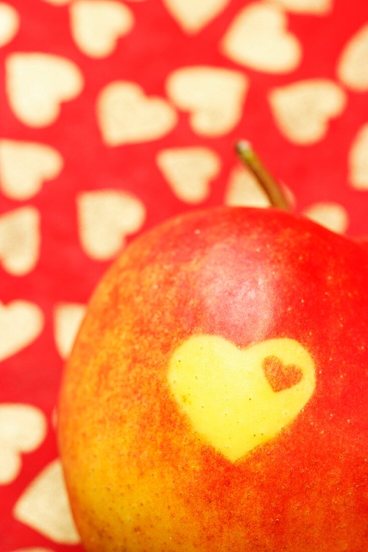 A heart carved into a red apple (detail)