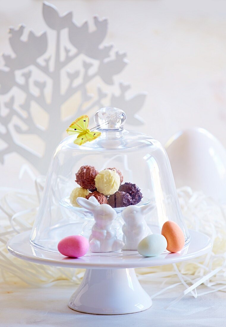 Truffle pralines under a glass cloches decorated for Easter