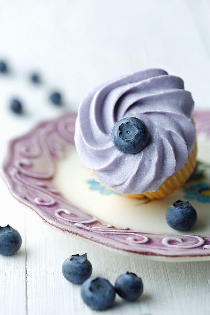 A cupcake with blueberries