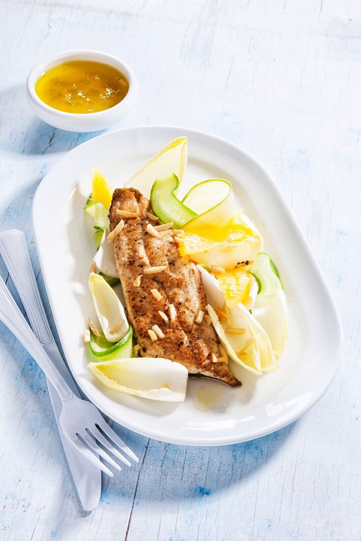 Crispy trout fillet with a chicory and courgette salad
