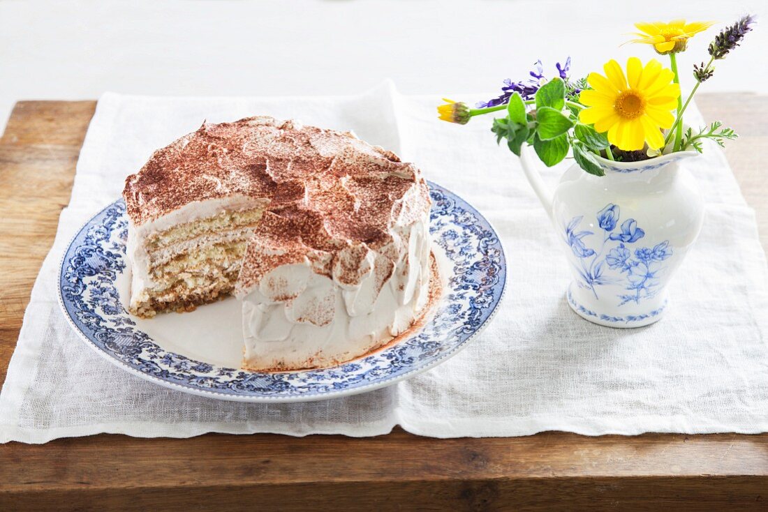 A layered coffee cream cake, sliced