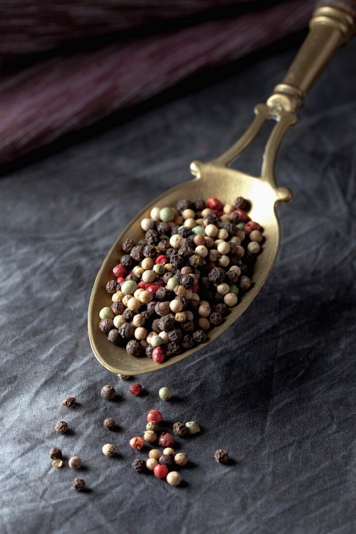 Coloured peppercorns on a measuring spoon