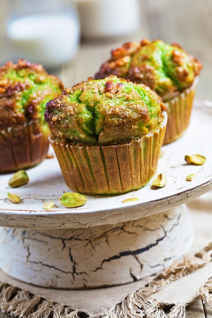 Pistachio muffins on an old cake stand