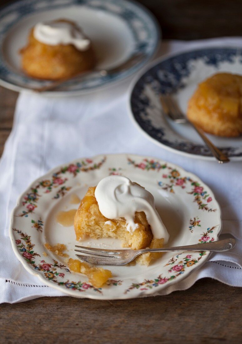 Pineapple cakes with cream, whole and with a bite taken out
