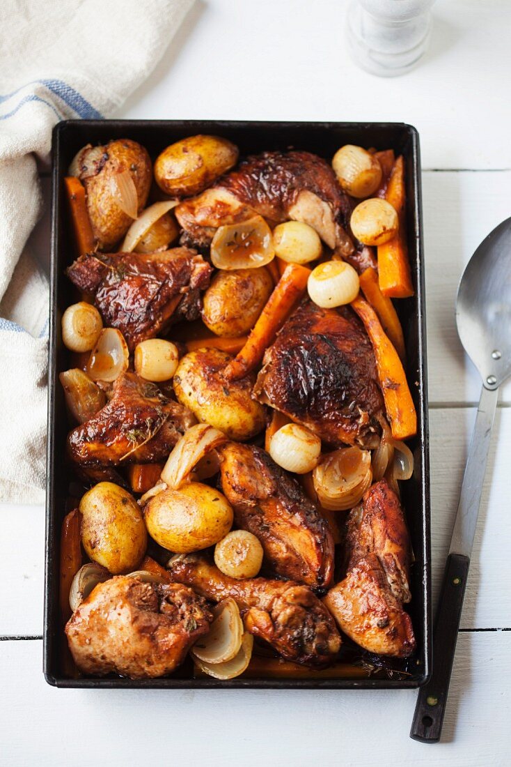 Roast chicken with potatoes, onions and carrots